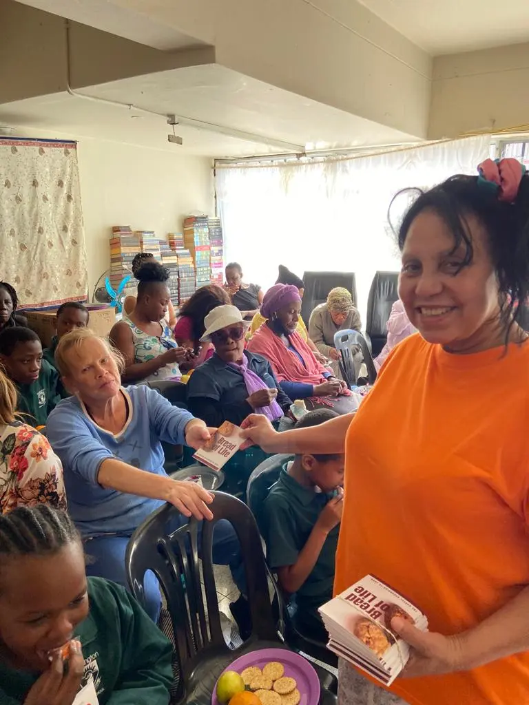 Our Story ministering to the ladies at a feeding scheme